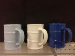 Custom mugs shaped like oil drums by Adco Marketing.